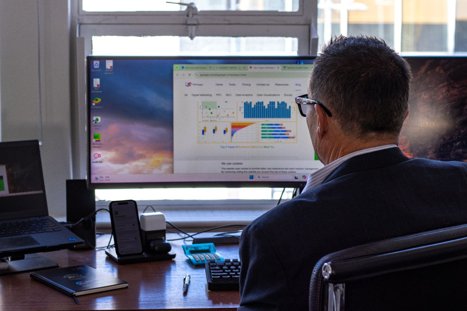 Accountant reviewing cloud accounting dashboards on a large monitor