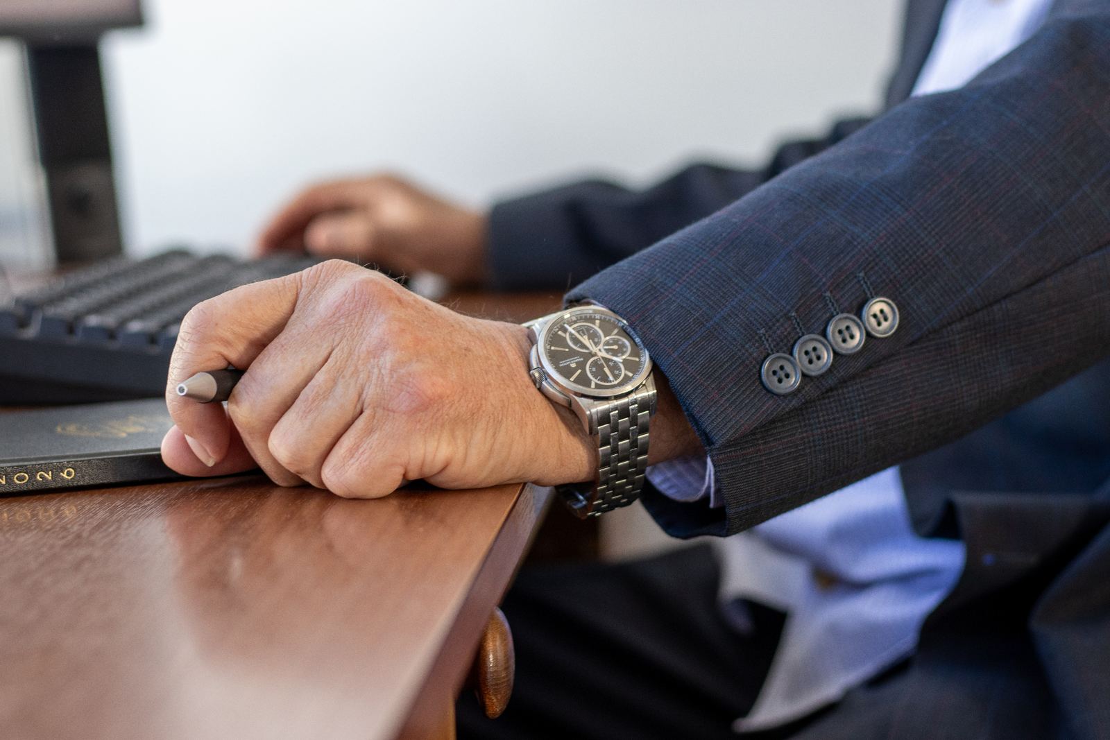 Close-up of an accountant working at a desk with keyboard and notebook