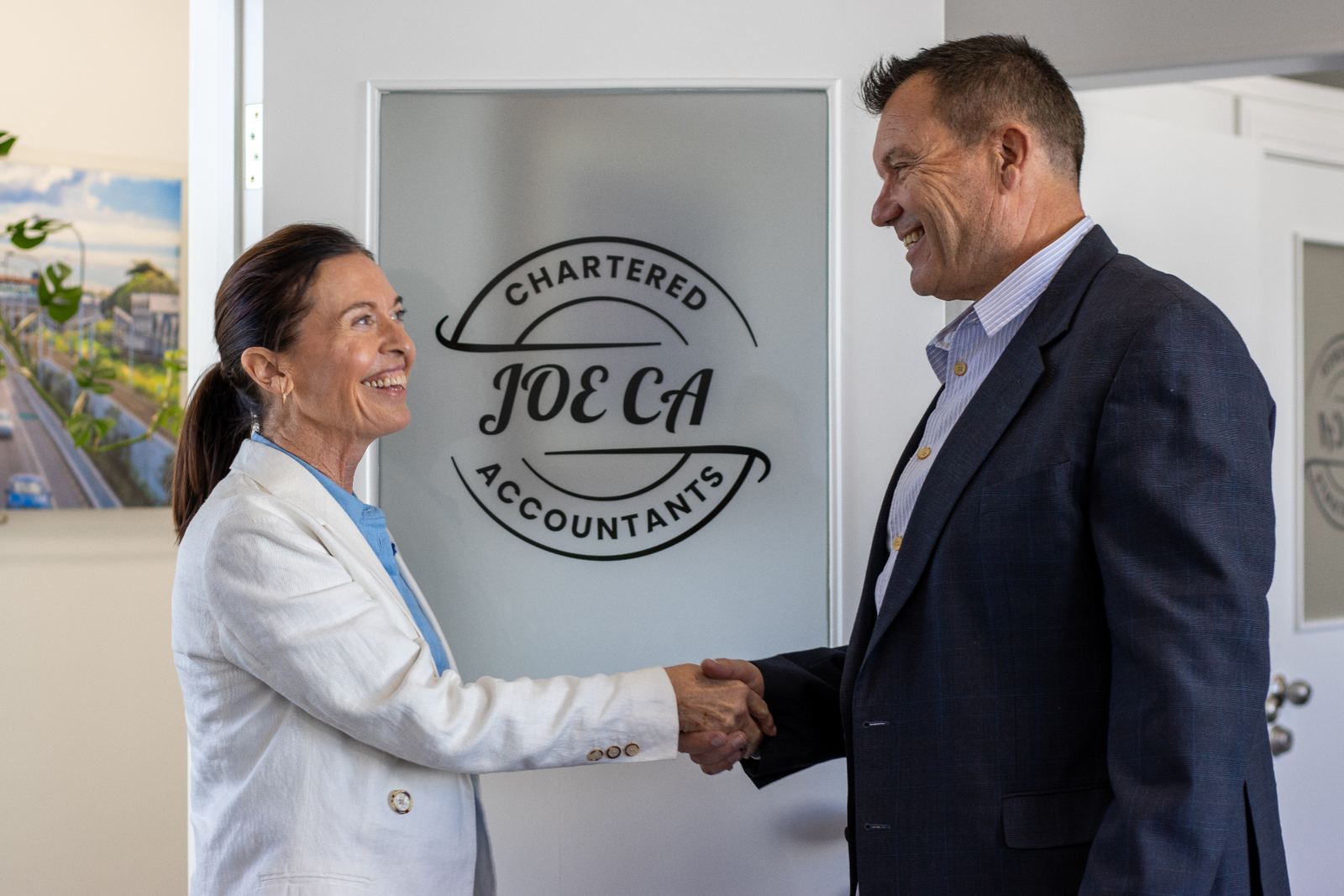 Joe shaking hands with a client in the JOE CA office