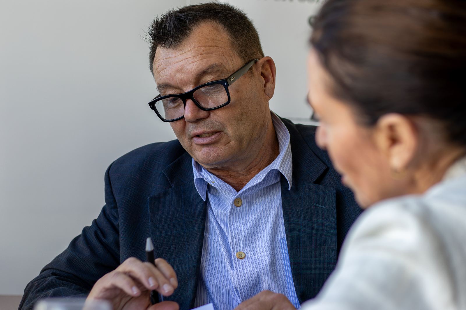 Joe discussing business plans with a client across a meeting table